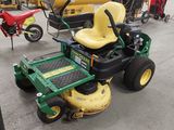 a lawn mower that is parked in a garage