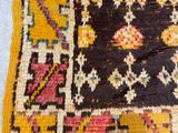 a close up of a yellow and black rug on a blue floor