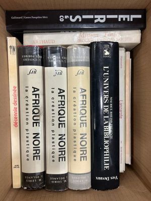 books in a cardboard box are stacked on top of each other