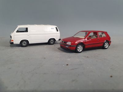 two toy cars sitting next to each other on a table