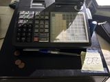 a calculator sitting on top of a table next to a stack of books