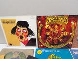 several different records are sitting on a white table