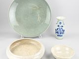 three bowls and a plate sitting on a table