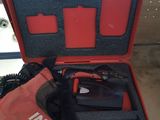 a red tool in a red case on a table