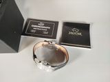a watch that is sitting on a table next to a box