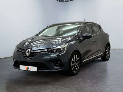 a grey car is parked in a room with white walls