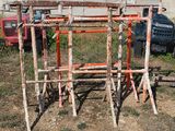 a pile of sticks sitting on the ground next to a truck