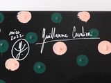 a black suitcase with pink and green polka dots on it