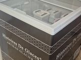 a glass display case with a remote on top of it