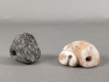 two small rocks sitting next to each other on a table