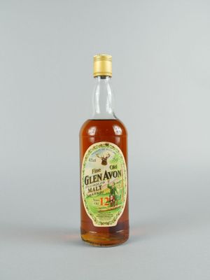 gros plan d'une bouteille de whisky sur une surface blanche