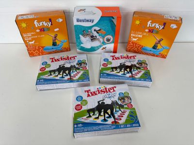 four boxes of twister toys sitting on a white surface