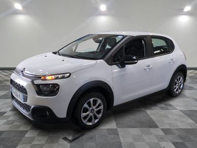 the white citrole is parked on a checkered tile floor