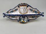 a blue and white plate with a clock on it