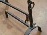 a metal rack with a handle on it on the floor