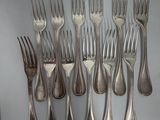 a lot of forks and spoons that are on the table