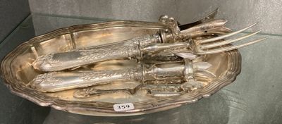 a silver plate with knives and knives in it