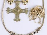 several pieces of jewelry including a cross, a ring, and a necklace