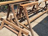 two wooden benches sitting next to each other on the sidewalk