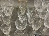 a lot of glasses and a decanter on the table