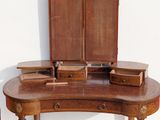 a wooden desk with a mirror on top of it