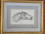 dessin représentant une tête de cheval dans un cadre doré, accroché à un mur en bois