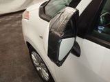a close up of a car ' s side mirror with a dog sitting in the passenger seat