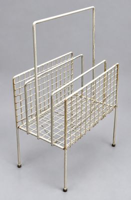 a white metal magazine rack on a gray background