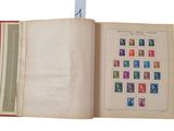 an open book with stamps on it on a white background