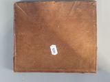 a brown box with a sticker on it sitting on a table