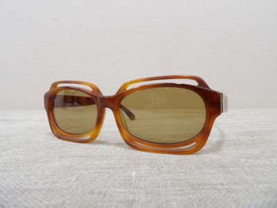 brown sunglasses with brown lenses on a white surface