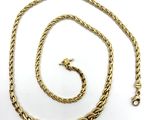 a close up of a gold chain on a white background
