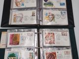 a lot of stamps in a folder on top of a table