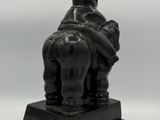 an image of a statue of an elephant with a hat on it ' s head