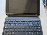 a laptop computer sitting on a table with a price tag on it