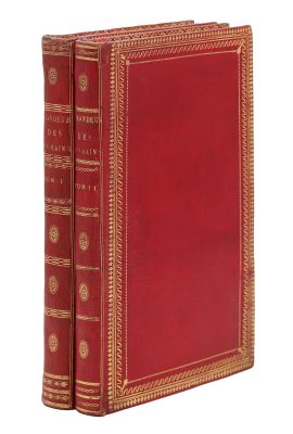 un vieux livre à la couverture rouge et à la bordure dorée