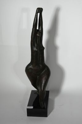 bronze sculpture of a woman holding her hands up in the air