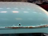 a close up of a car with rust on the hood