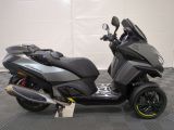 a picture of a motor scooter parked in a garage