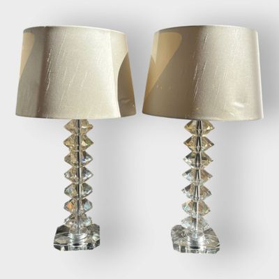 pair of crystal table lamps with lampshads on each of them