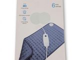 La boîte du coussin chauffant est ouverte et le produit est prêt à l'emploi.