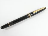 a close up of a pen on a white surface with a white background