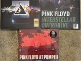 two pink floyd cds are sitting on the floor next to each other