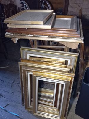 a lot of picture frames stacked on top of each other