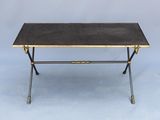 a black and gold coffee table with brass legs
