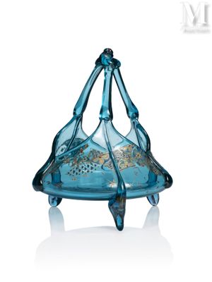 a blue glass object that is sitting on a white surface