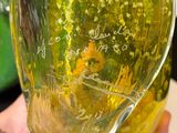 a person holding a glass of liquid in their hand