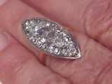 a person holding a diamond ring in their hand