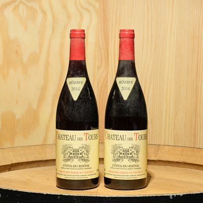 two bottles of wine sitting on top of a barrel