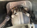 a close up of a car ' s engine with a hose attached